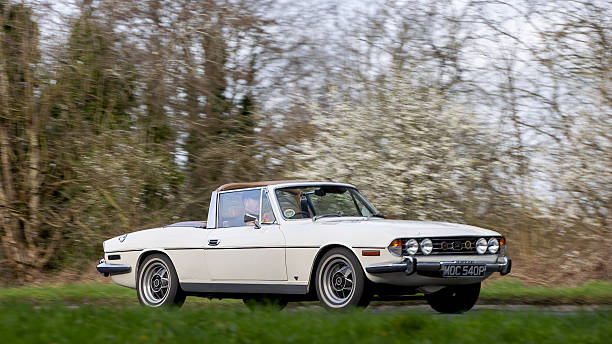 Milton Keynes,Bucks,UK - Mar 1st 2026:  1976 white Triumph Stag classic  car driving on a British road