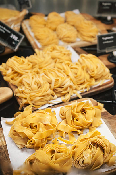 fresh Italian pasta, in particular such types as Tagliatelle and Fettuccine . Pasta is rolled up into characteristic nests and laid out on wooden boards, which found in Italian bistros pasta shops
