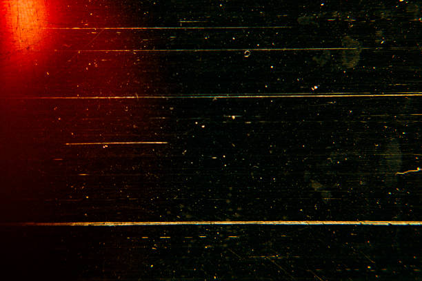 Abstract dark cinematic background with deep scratches and red light leak. Perfect for moody vintage film effects and creative grunge designs. Features artistic grain.