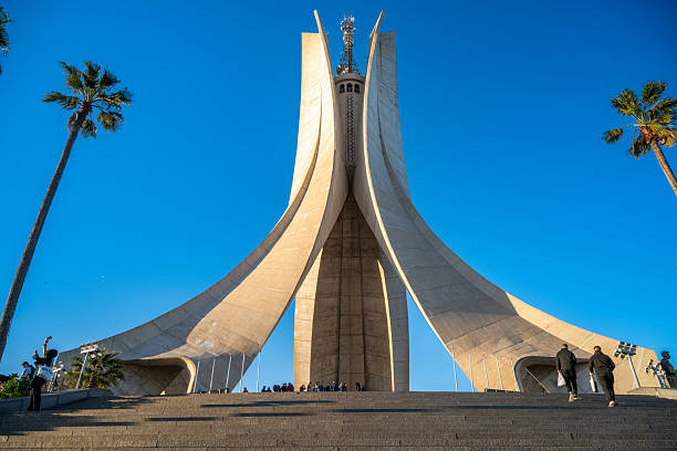 21 February 2026 Algiers, Algeria. Visitors walk on the steps of the Martyrs’ Memorial monument (Maqam Echahid) under a clear blue sky in the Algerian capital. The Martyrs’ Memorial, also known as Maqam Echahid, is a major national monument in Algiers commemorating Algeria’s independence. The concrete structure rises prominently above the city and is one of the most recognizable landmarks in the country.