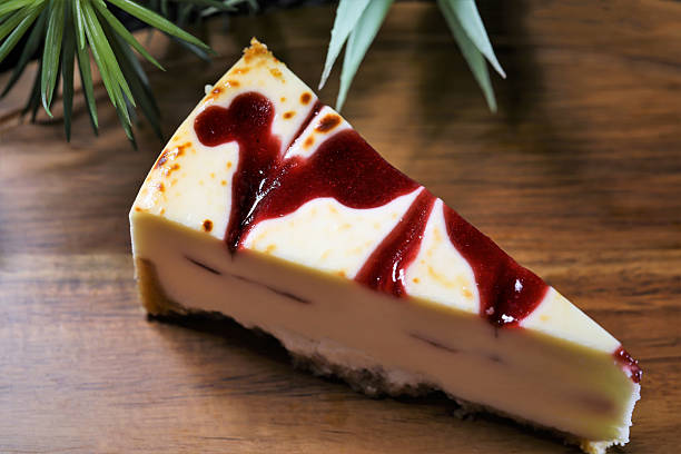 Delicious slice of raspberry cheesecake with berry sauce on top