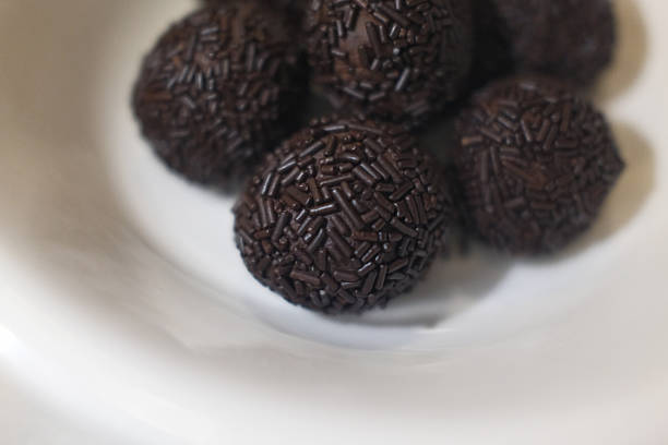 Delicious chocolate truffles served as an elegant dessert, coated in cocoa powder and rich in flavor. Ideal for themes such as gourmet sweets, confectionery, celebration, and indulgent treats.