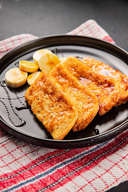 French toast sweet toasts with syrup bread fried in egg breakfast tasty snack fresh gourmet food background on the table rustic food top view copy space