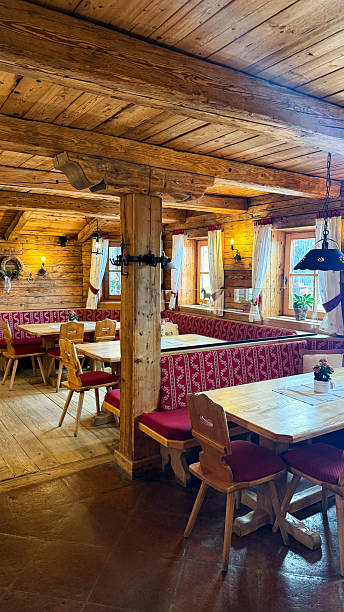 Interior of a traditional log cabin restaurant features wooden tables and benches for dining