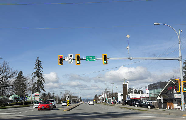 Surrey, Canada - February 28, 2026: Looking northwest on Highway 99A at 32nd Avenue Diversion. Retailers and residential buildings line South Surrey. Increasing clouds on a winter afternoon in Metro Vancouver.