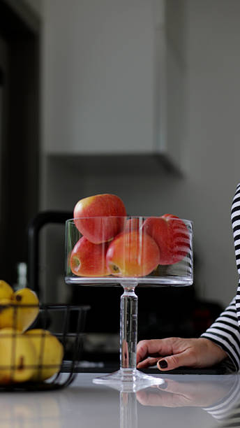 Beautiful Display of Fresh Red Apples in Glass Bowl – Vibrant Organic Fruit Arrangement, Healthy Nutrition and Natural Kitchen Aesthetic