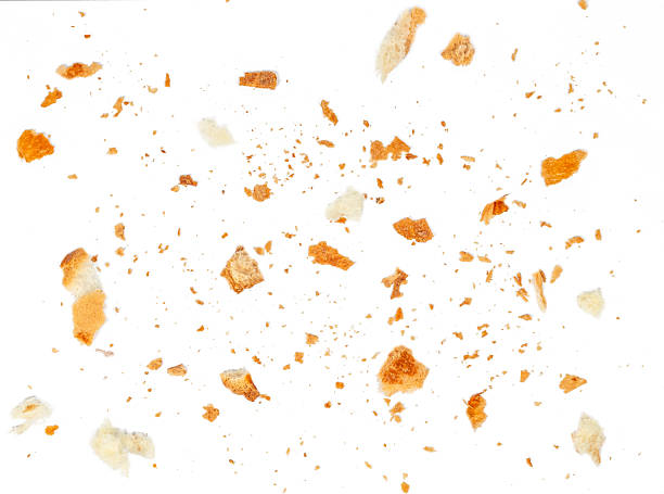 Croissant Crumbs Scattered on Light Background with Copy Space