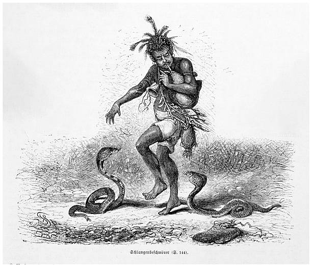 A 19th-century engraving depicts a snake charmer with cobras. The man is playing a flute, wearing a headdress and traditional clothing. Exotic scene.