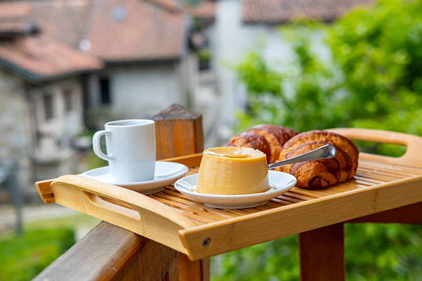 breakfast with creamy pudding panna cotta, fresh croissants, and coffee, Italian Morning, rustic village from balcony, Authentic Italian Charm