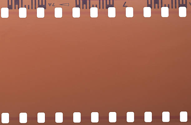 Close up of an old 35mm film strip on a white background.