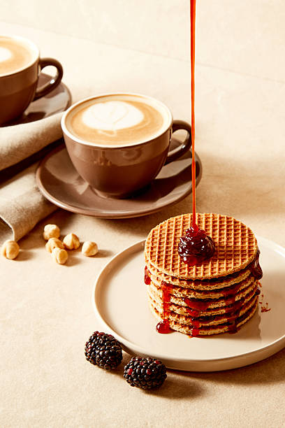 Stack of Waffles with Berry Sauce Drizzle and Coffee Cups on Cozy Breakfast Table