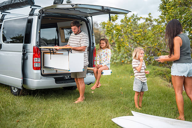 Caucasian Father Prepares Breakfast with Family on Camping Trip