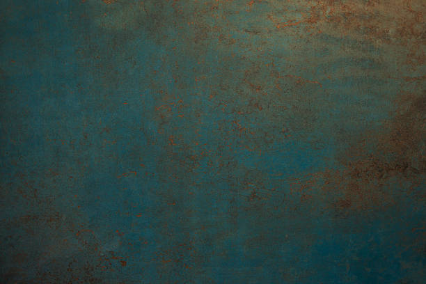 Teal metal surface with weathered copper and rust textures, distressed patina and industrial grunge pattern, full-frame close-up ideal for backgrounds or design