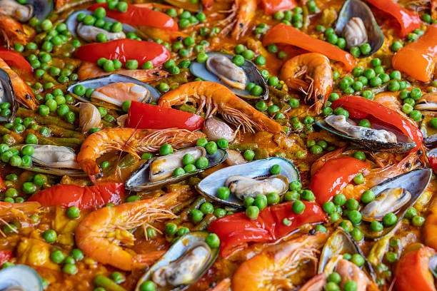 Spanish seafood paella in fry pan with mussels, shrimps and vegetables