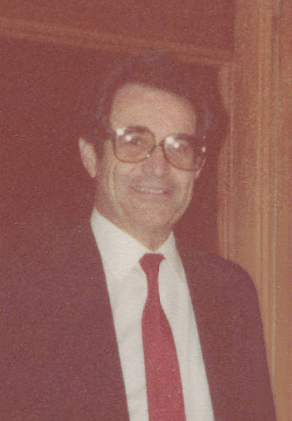 Image taken in 1971: Smiling Mature businessman posing with  looking at camera