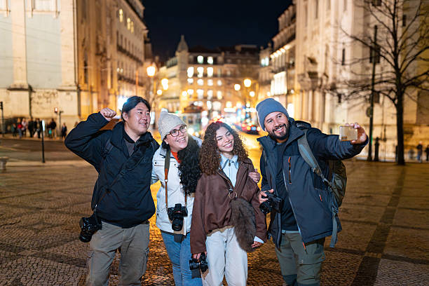 Friends taking a selfie in Lisbon at night