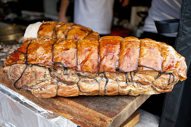 Traditional Roasted Porchetta Pork Belly on Wooden Cutting Board