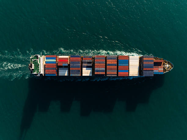 Aerial Top-down View Of A Large Container Cargo Ship On The Open Sea.