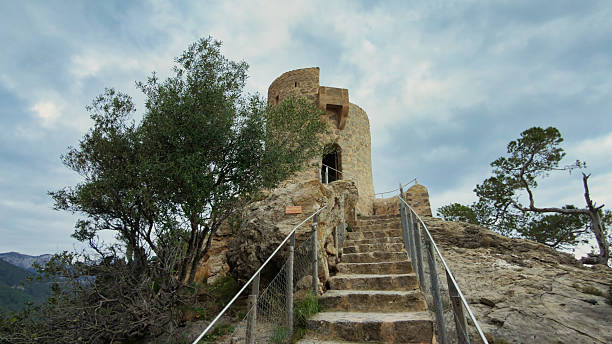 Ancient Torre des Verger stone watchtower on a rocky cliff in Banyalbufar, Mallorca, Spain