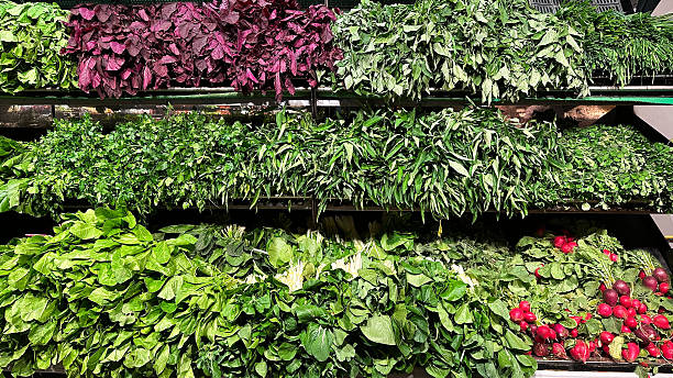 Fresh organic vegetables and herbs displayed on market shelves