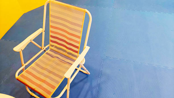 Striped Beach Chair on Blue and Yellow Background