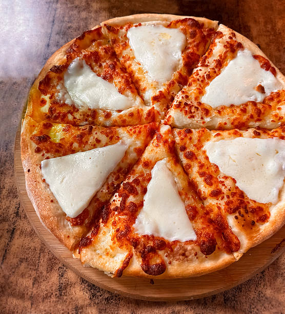 Triangular pizza slices arranged in a circle on a plate, top view