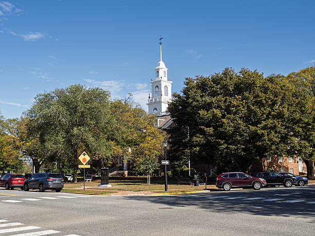 Dover Delaware USA-10 15 2025: View across a street intersection toward the prominent white steeple of the historic Legislative Hall (State Capitol) on The Green in Dover, Delaware.