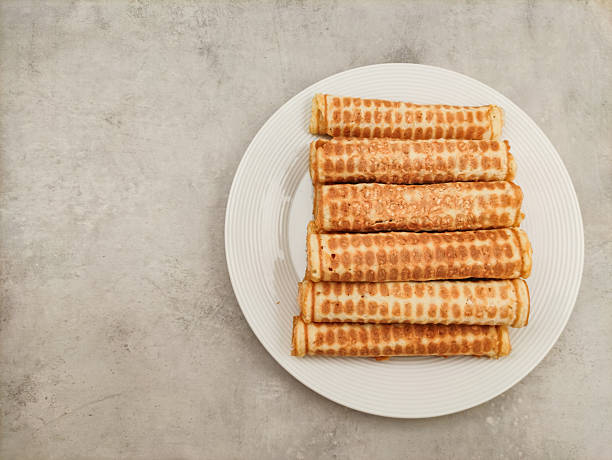 Waffle rolls presenting on white plate and marble table