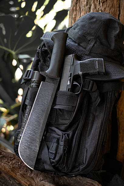 machete knife and a hiking backpack rest on a log.