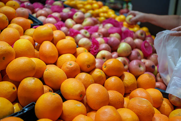 Close Up of Person Selecting Fresh Apples in Supermarket