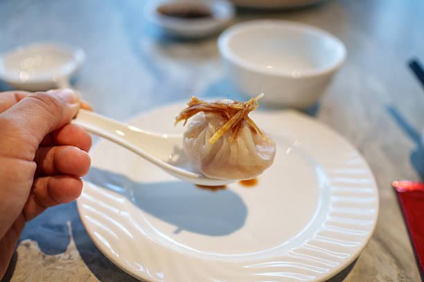 Xiao Long Bao Soup Dumpling with Ginger on Spoon