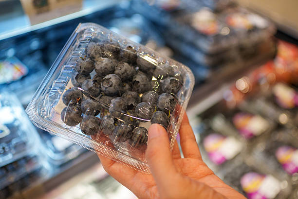 Fresh blueberries in clear plastic packaging at a grocery store