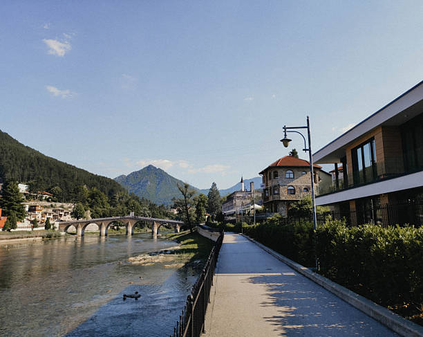 Riverside walkway with stone bridge in Konjic. Scenic Bosnia and Herzegovina landscap, calm travel mood