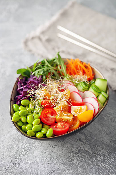 Buddha Bowl. Cucumber, carrot, arugula, red cabbage, edamame beans and sesame seeds. The concept of delicious balanced and healthy food.
