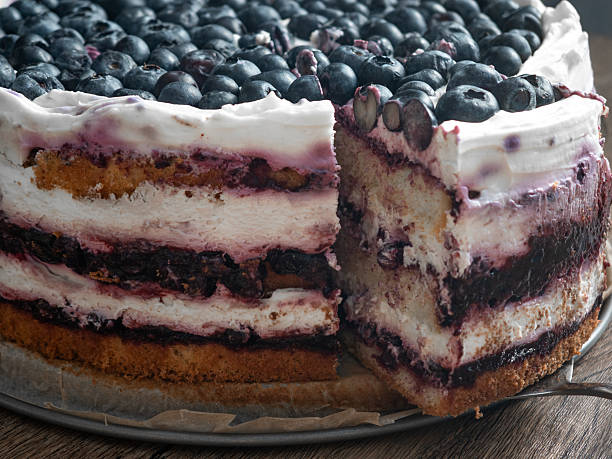 A close-up cross-section of a layered blueberry birthday cake