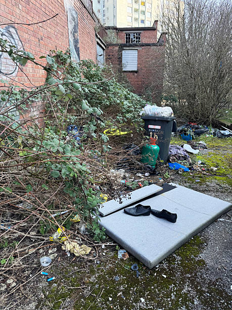 Fly tipping on overgrown land next to derelict buildings in the Redcliffe area of Bristol, UK. March 2026