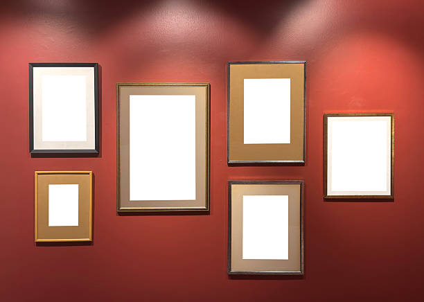 Empty antique wooden photo frames on a red background.