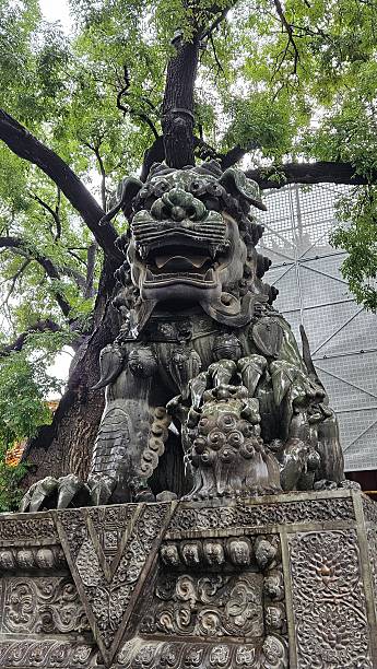 Majestic traditional Chinese guardian lion statue in Beijing, China.