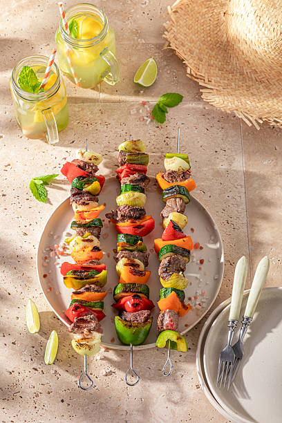 Spicy roasted skewer served with lime and herbs.