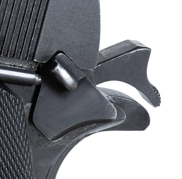 Close-up of the safety activated on a 1911-style semi-automatic pistol isolated on a white background.