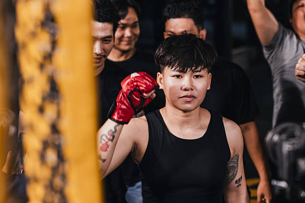 Female MMA fighter walking into the ring.