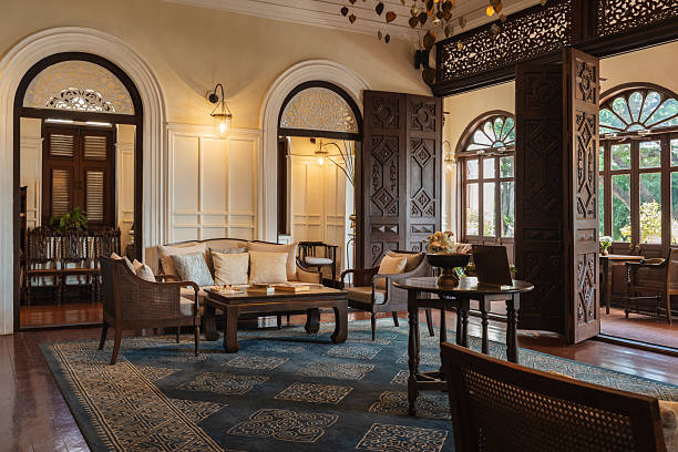 Stylish hotel lobby with wooden furniture, comfortable seating, a decorative chandelier, and classic architectural details.