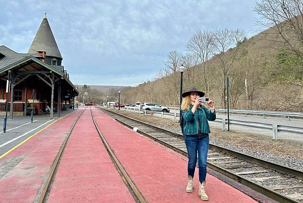Photographer Taking Picture Of Train Rails – Free Stock Photo