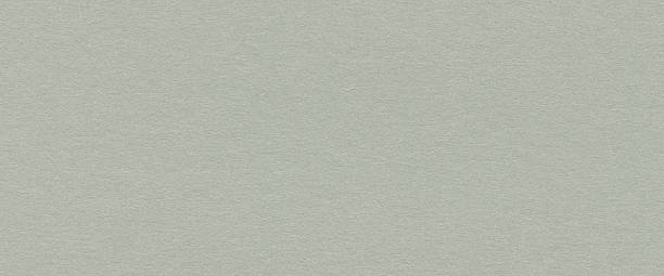 Close up of light green paper texture with subtle fibers and rough surface for creative design. Blank background with natural pattern
