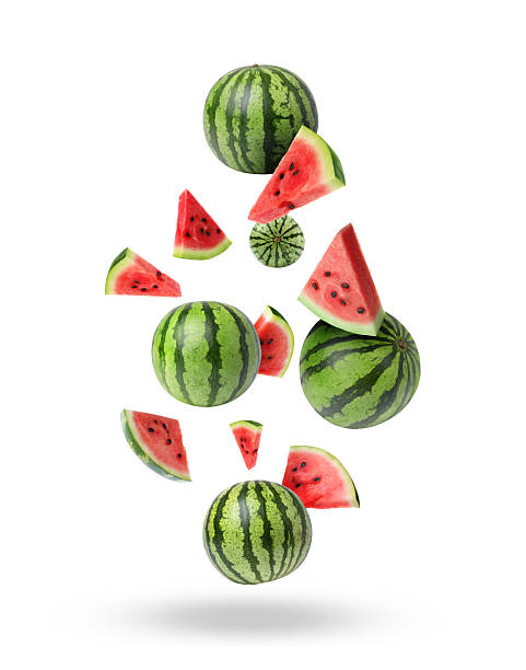 Fresh watermelons falling against white background. Summer fruit