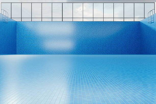 Empty Indoor Swimming Pool with Blue Mosaic Tiles and Large Windows