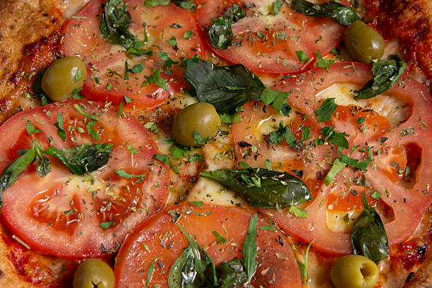 Close up of Neapolitan pizza with tomato and basil