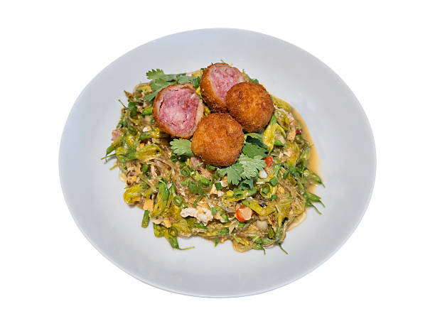 Stir-fried glass noodles with egg, fermented pork (naem) and sesbania flowers, isolated on white background with clipping path