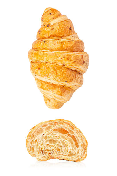 Whole croissant and cut croissant crumb isolated on white background