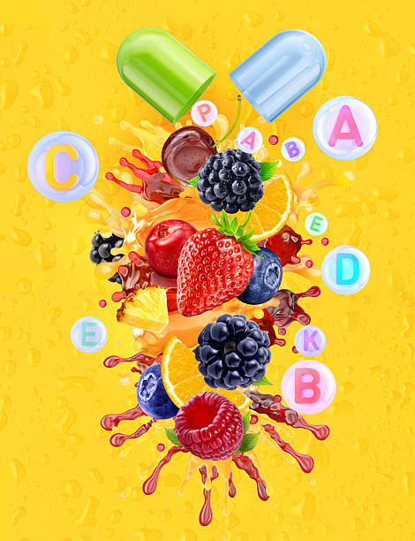 Nutritional supplement capsules releasing fresh berries and citrus fruits with juice splashes on a yellow background